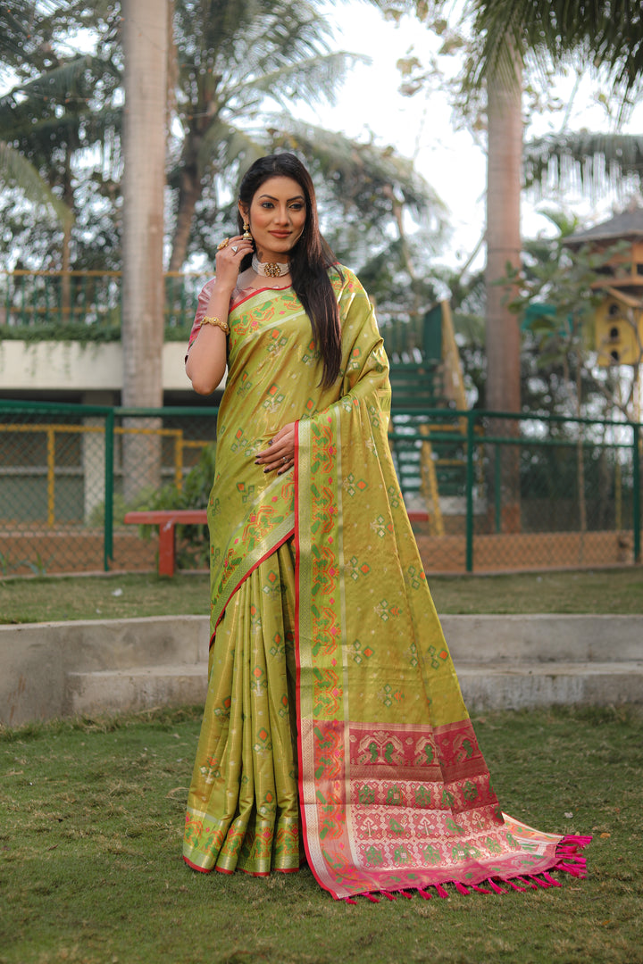 Stylish olive organza saree with a delicate Ikkat Patola design, perfect for cultural events and gatherings.