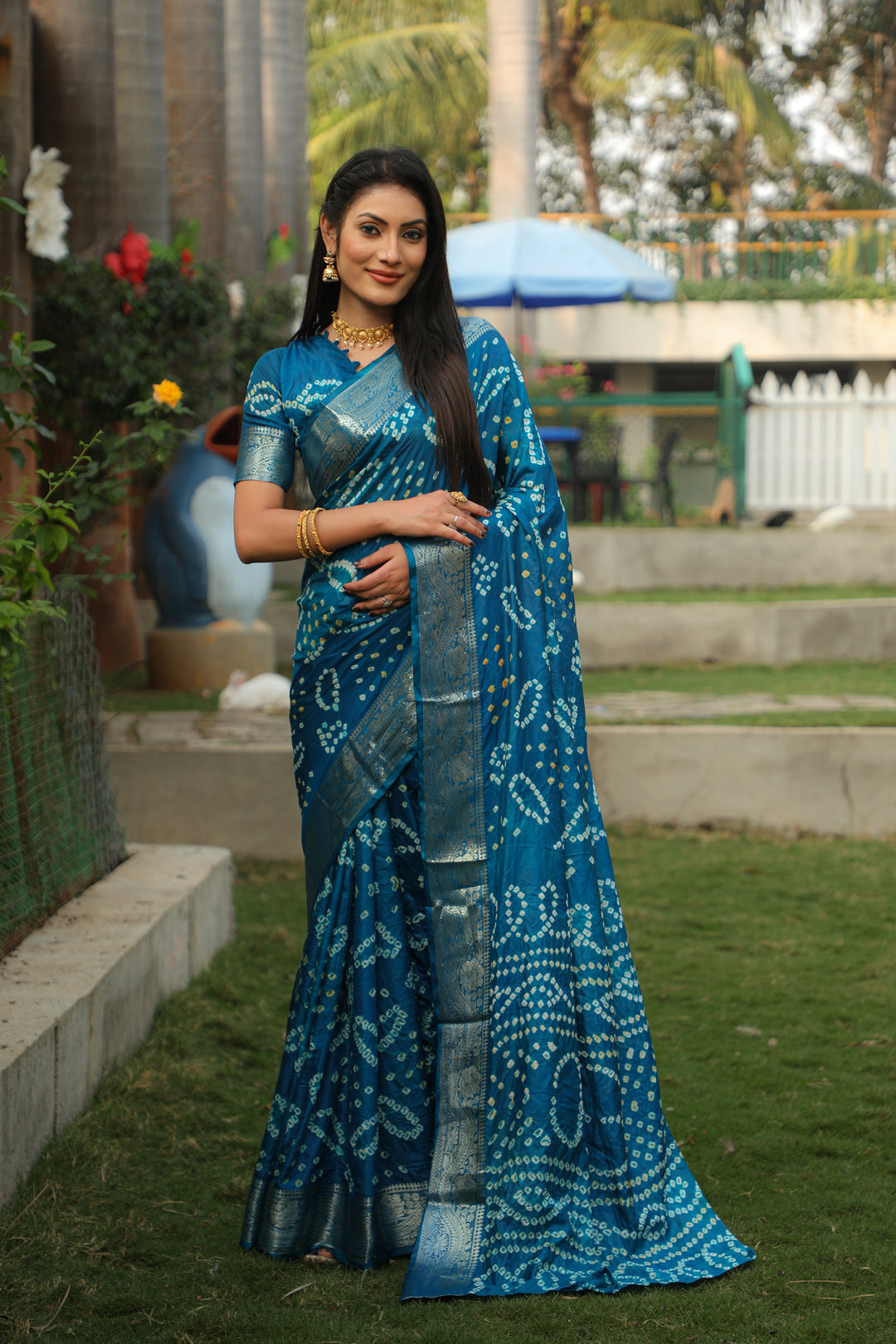 Elegant teal blue Kanjivaram Bandhej silk saree with intricate jari weaving and Bandhej pallu, ideal for special occasions.