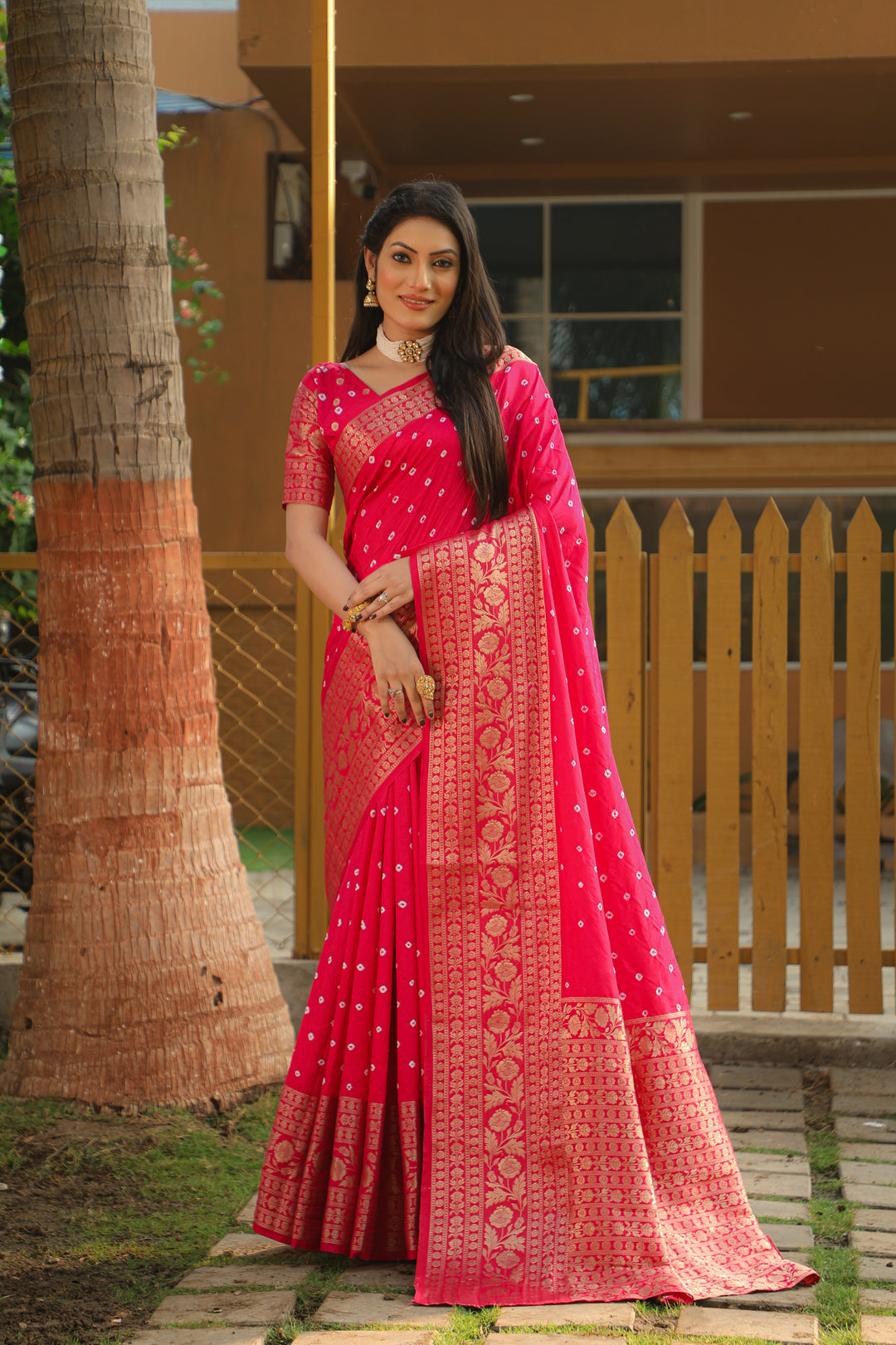 Exquisite pink Bandhej Kanjivaram silk saree featuring intricate zari weaving and a rich pallu, perfect for bridal wear and cultural events.