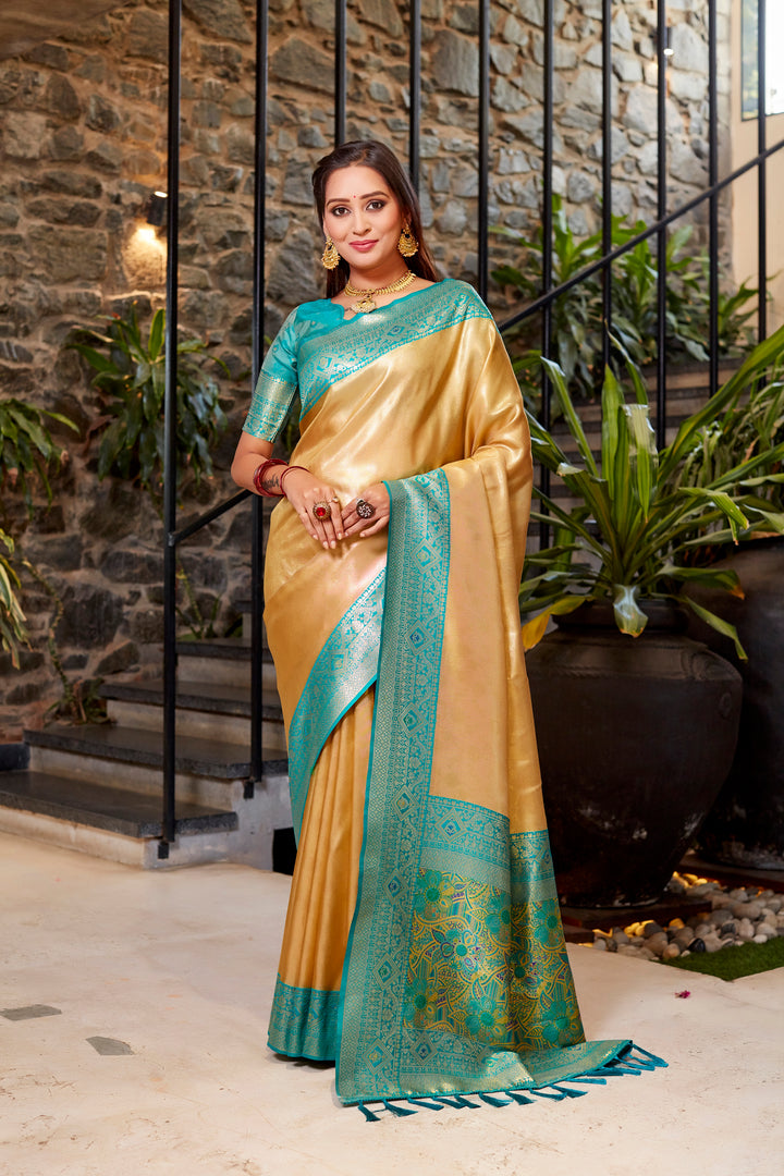 Stunning golden Tissue silk saree with intricate weaving and rich contrast border details.