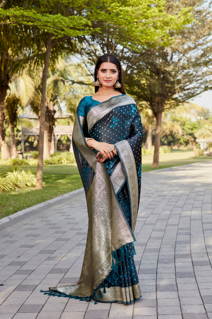 Beautiful teal-blue Satin Kanjivaram saree with delicate butta design and a shimmering finish.