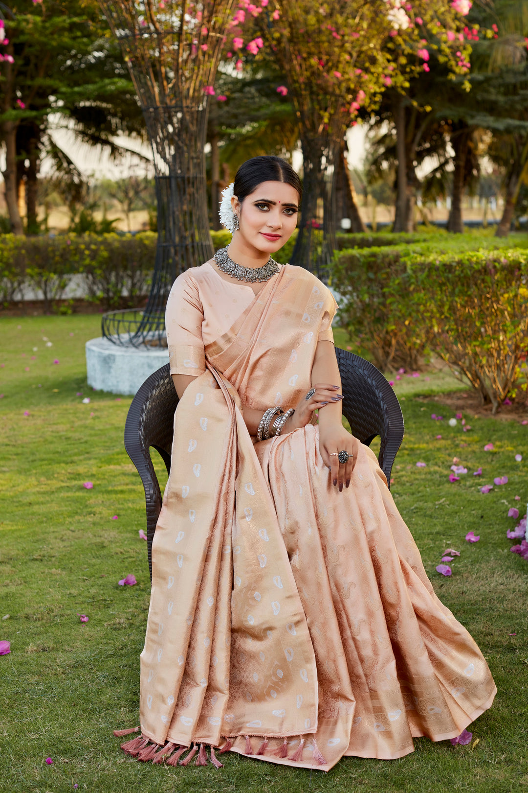 Stunning beige Kanjivaram satin silk saree with delicate butta designs and woven pallu, ideal for celebrations.