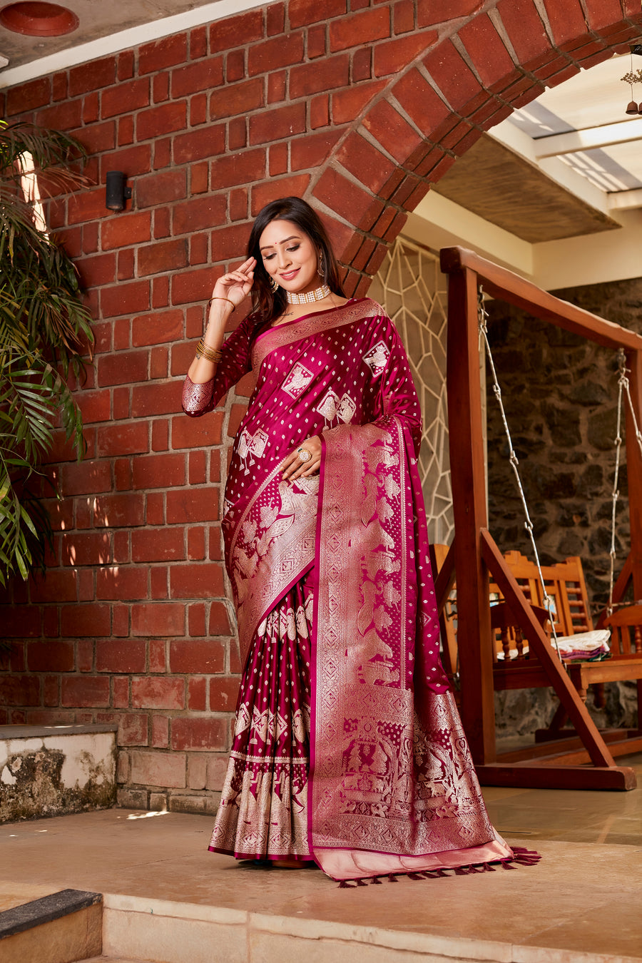 A luxurious wine Kanjivaram soft satin silk saree with intricate weaving and a rich pallu, perfect for weddings and festivals.