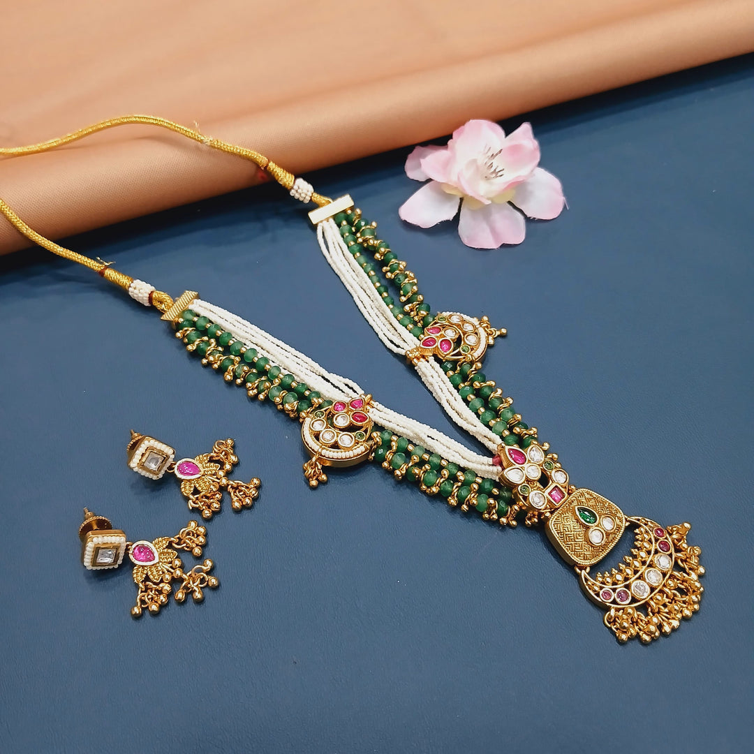 Antique-inspired Indian choker set in gold metal, suitable for weddings and traditional events.