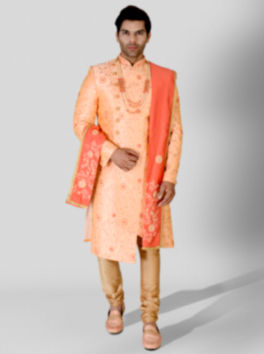 Peach Indo Western men's set with floral embroidery and asymmetrical hem.