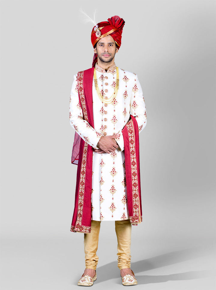 Regal embroidered sherwani in cream and maroon, crafted for weddings and special events.