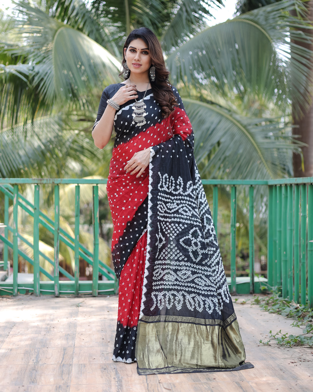 Premium Black Bandhej Silk Drapes featuring Zari Tissue Pallu and blouse piece for a chic, elegant appearance.