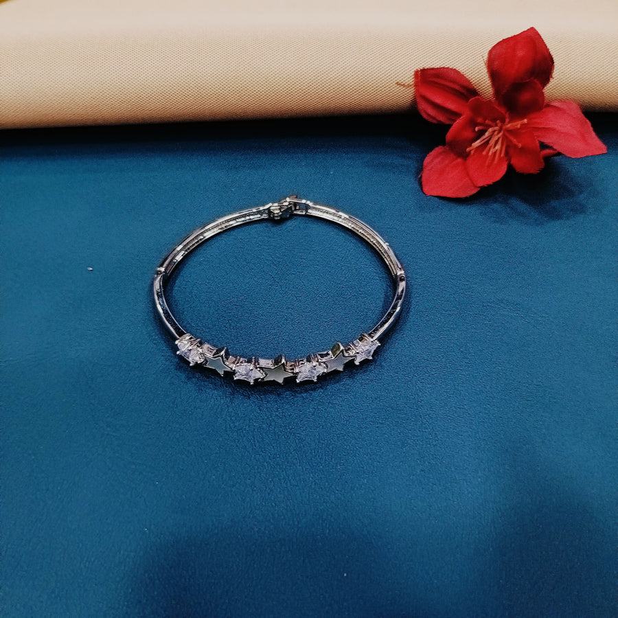 Stylish silver bangle with intricate engravings, ideal for special occasions.