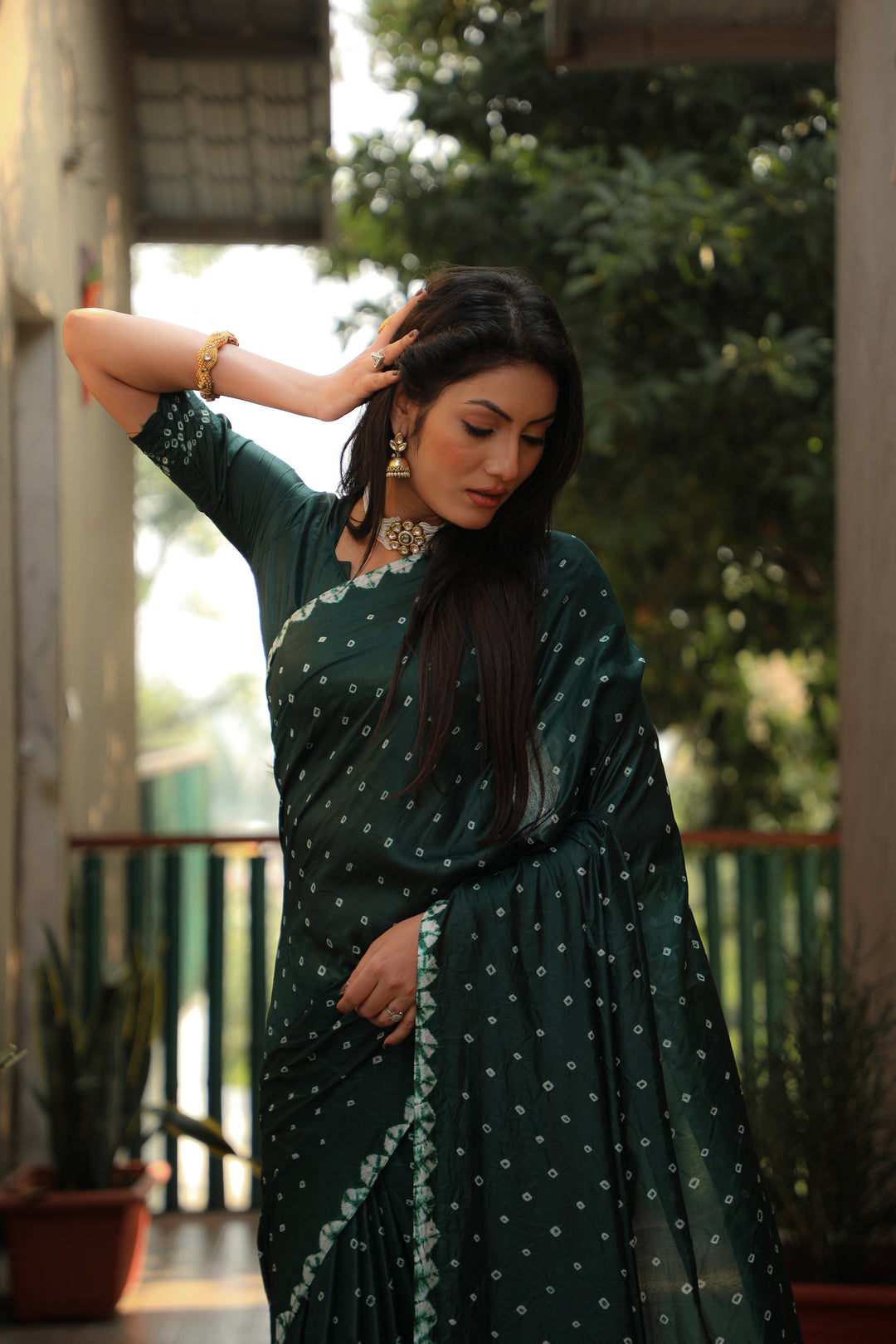 Stunning teal-green Bandhej silk saree with stylish checks pattern, ideal for festive occasions.