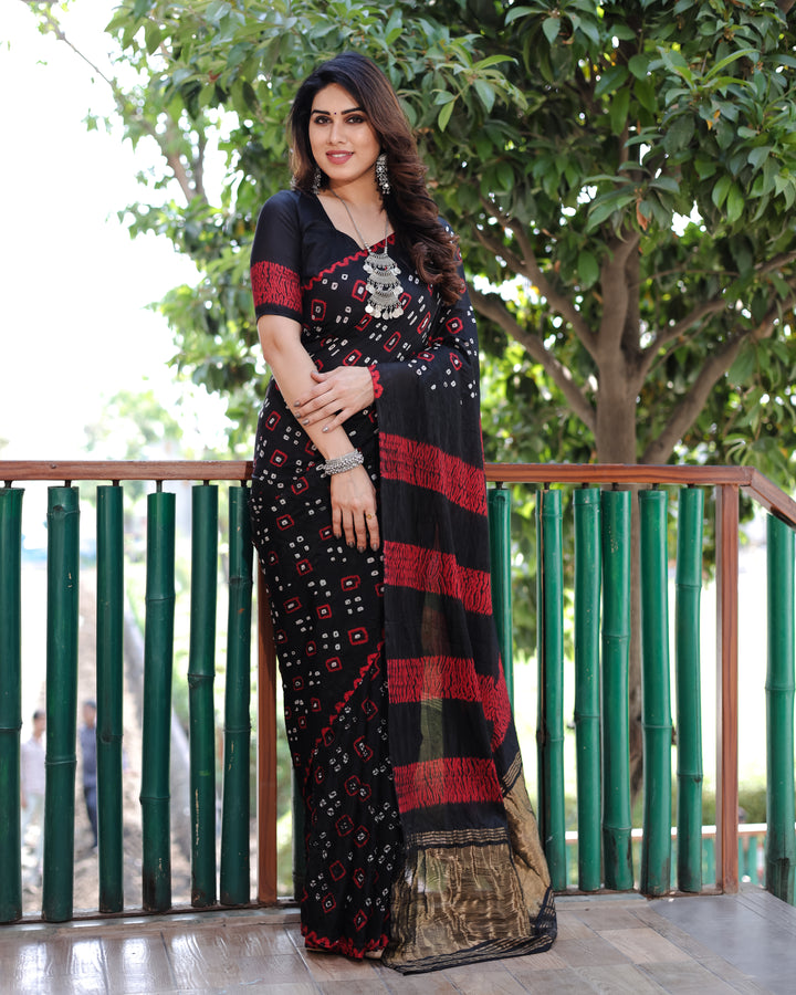 Black Bandhej silk saree with a dazzling tissue pallu, making a statement with its timeless elegance and traditional charm.