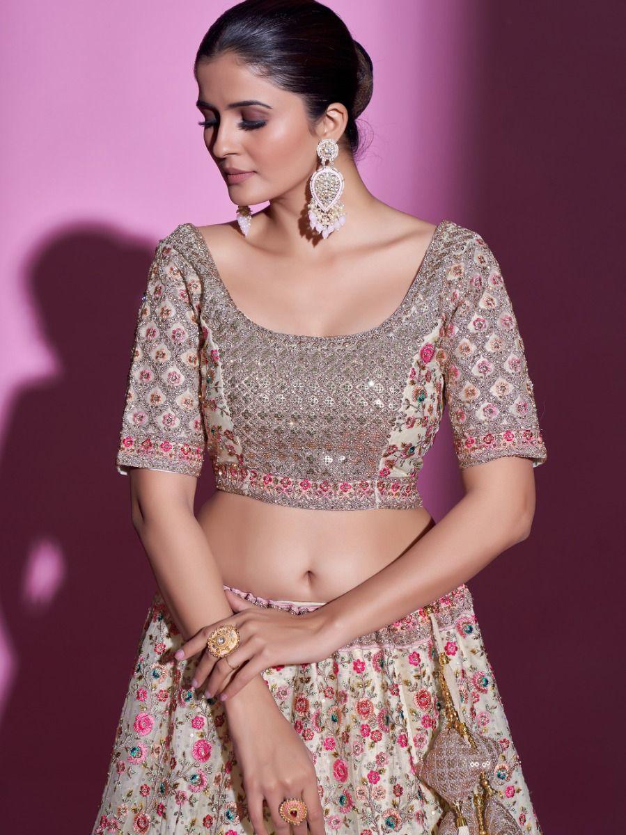 Cream designer lehenga with embroidery and sequins for special events.