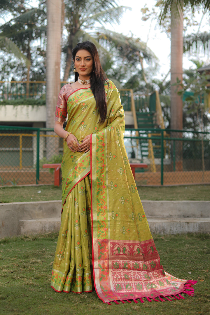 Graceful olive organza saree with Ikkat Patola print, ideal for traditional occasions and festive wear.