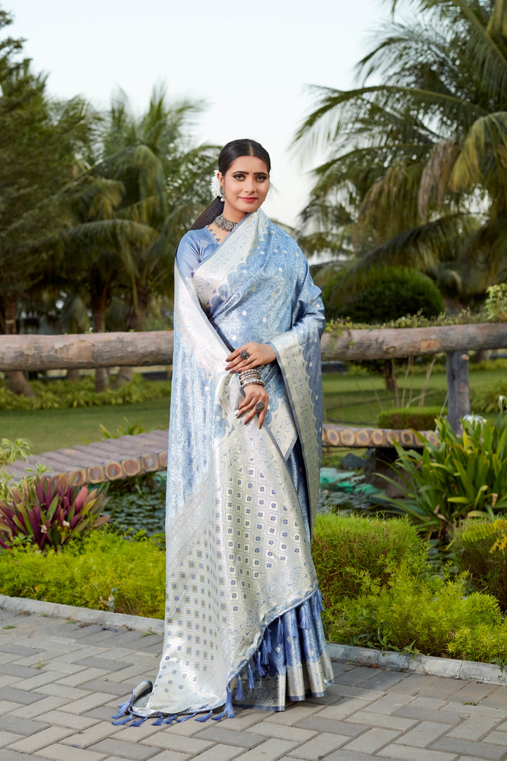 Rich blue Kanjivaram silk saree with intricate butta work and designer border, ideal for traditional ceremonies.