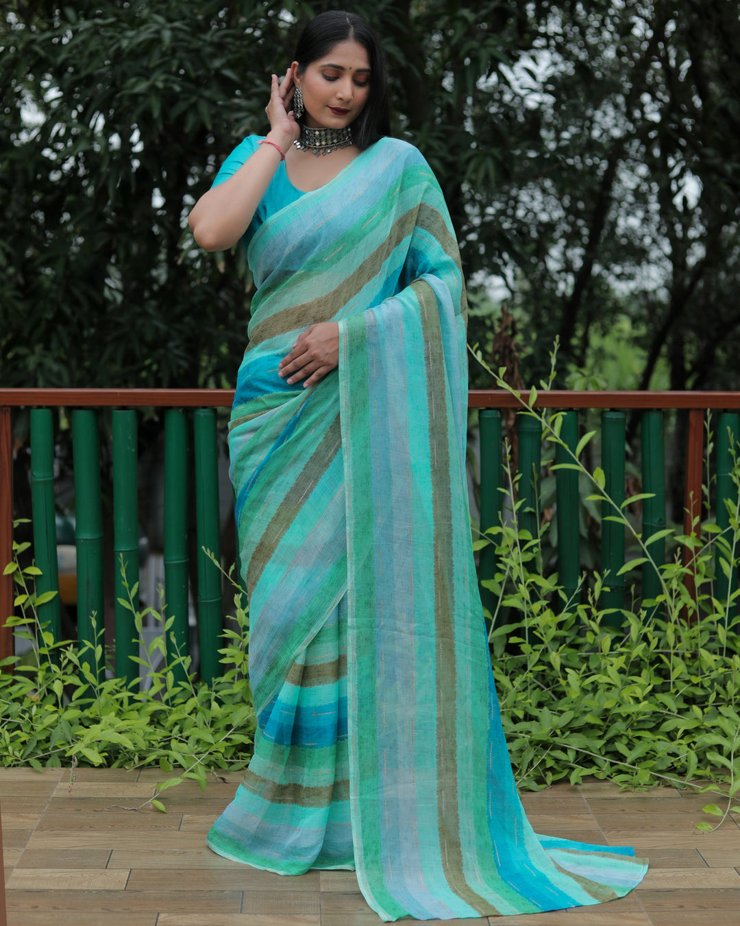 This sky blue Moss chiffon saree features delicate gold foil detailing, adding a soft and graceful touch to your festive wardrobe.