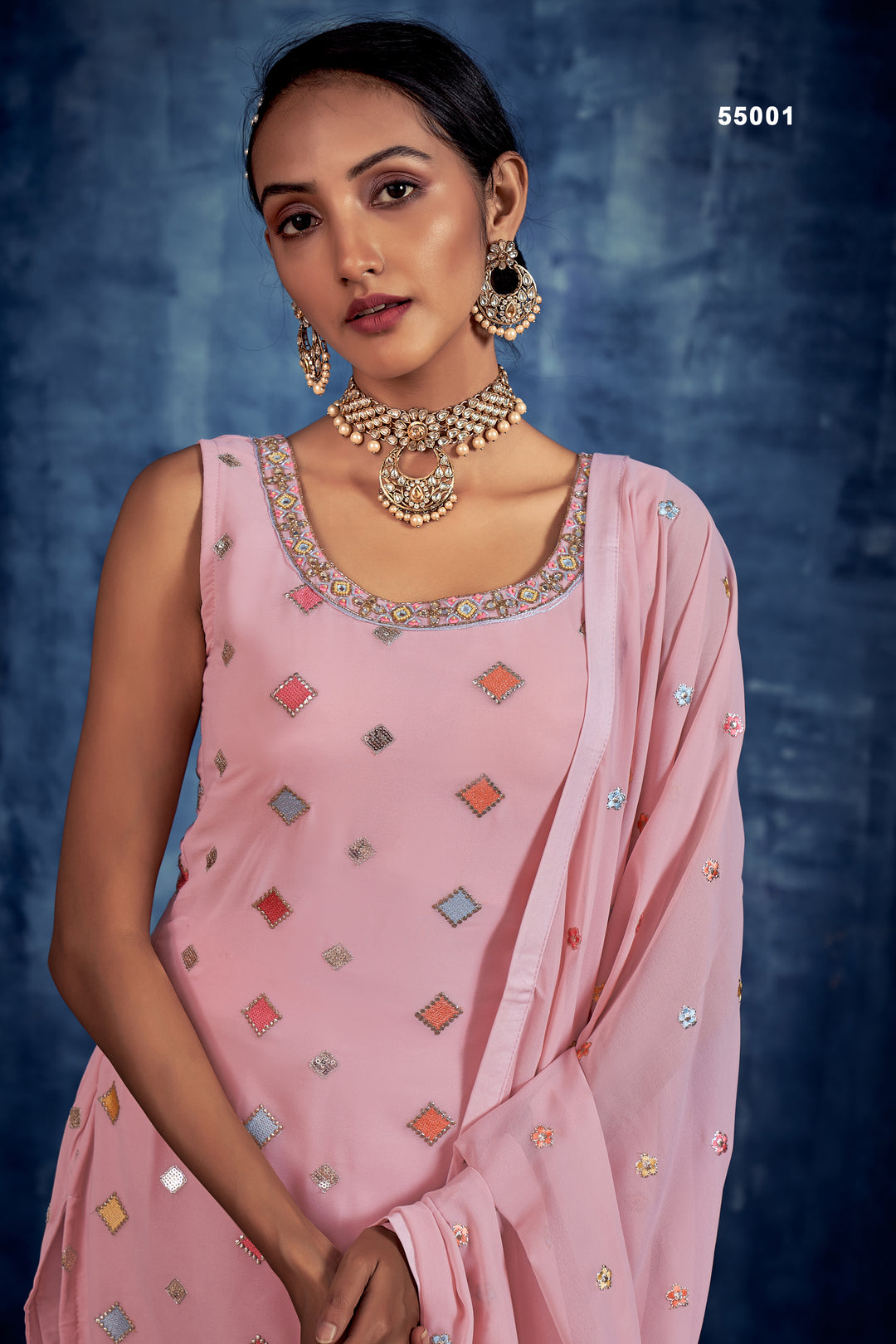 Elegant baby pink wedding sharara style suit with golden zari, stones, and beads.