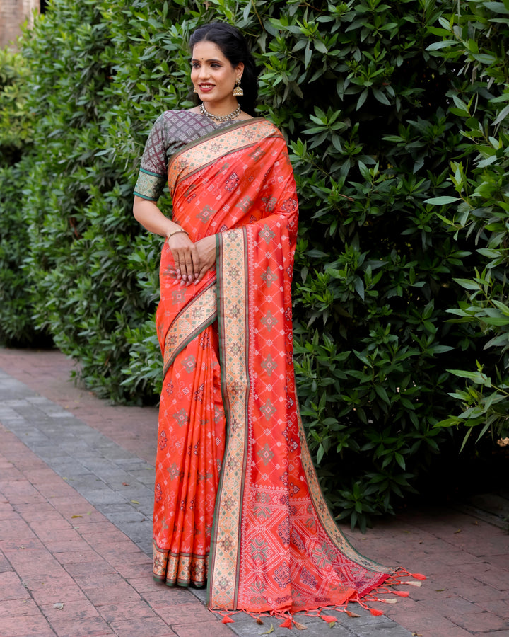 Embrace tradition and elegance with this stunning orange Ikkat Patola silk saree featuring Kanchi-style borders and intricate Zari work.