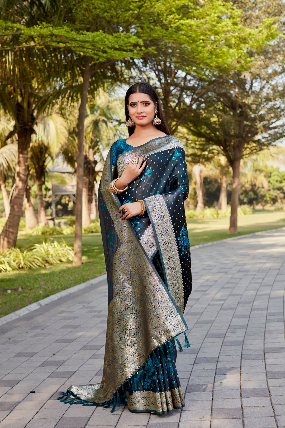 Teal-blue Satin Kanjivaram saree with intricate butta motifs and radiant shimmer.