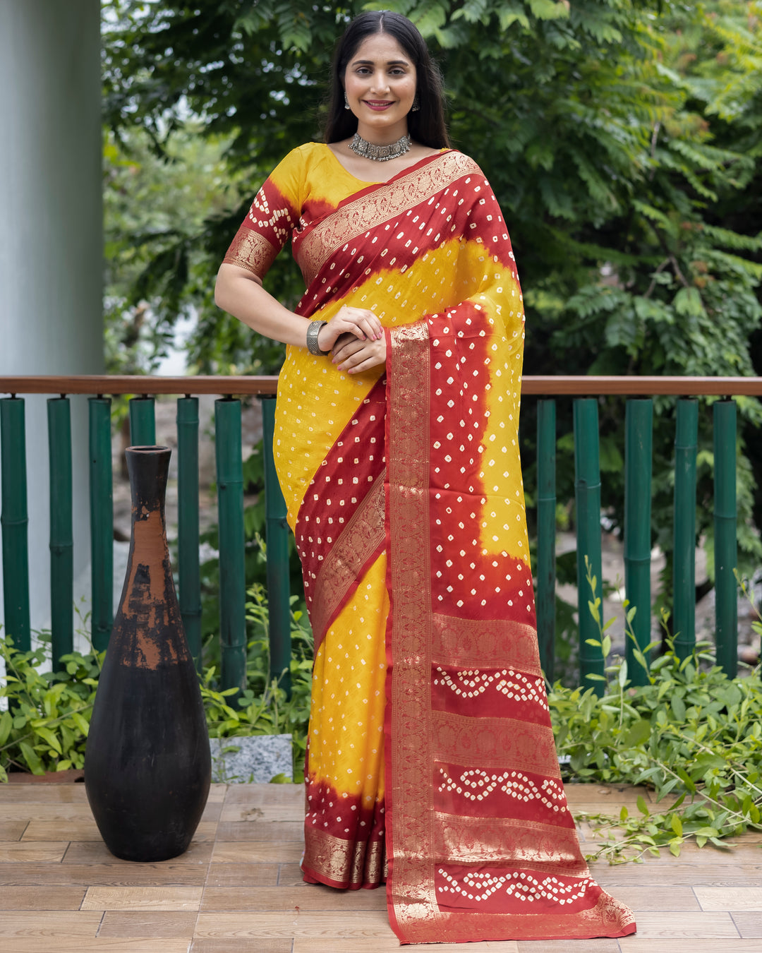 Graceful yellow Bandhej silk saree with detailed zari work and matching blouse, perfect for bridal wear.