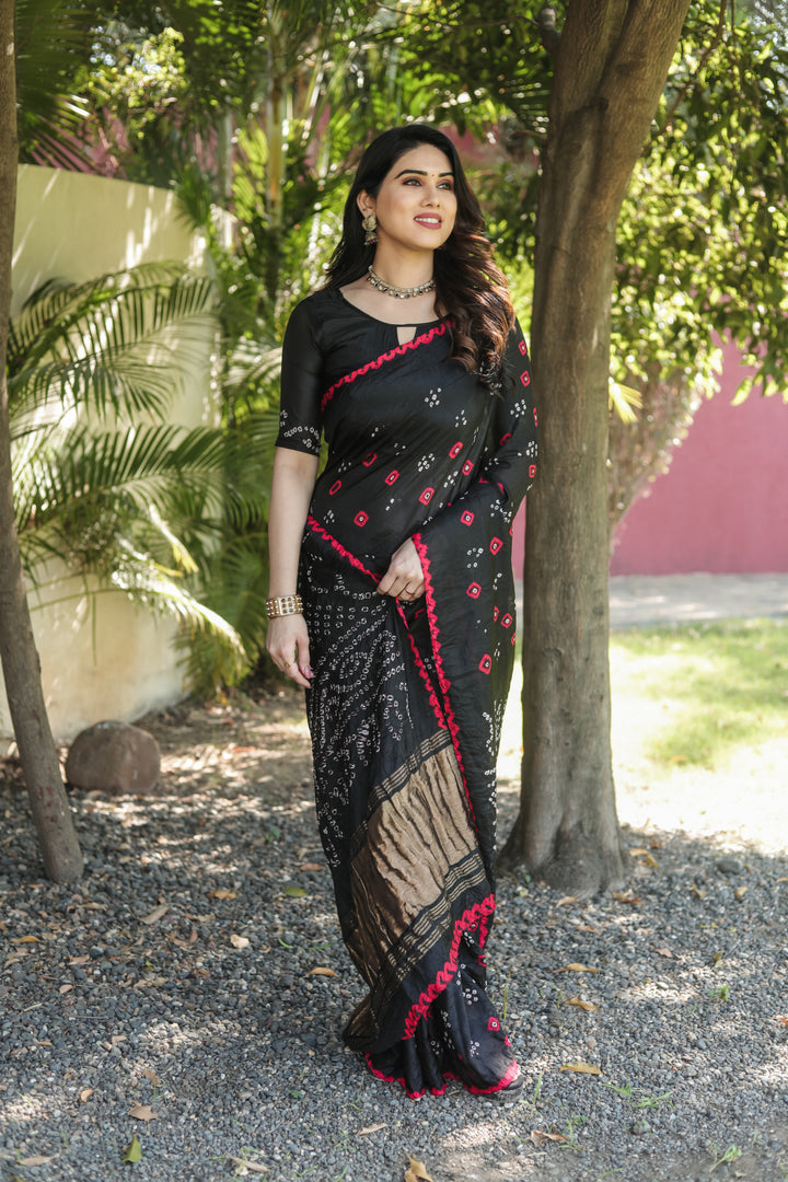 Traditional Bandhej silk saree with intricate zari weaving and elegant tissue pallu.