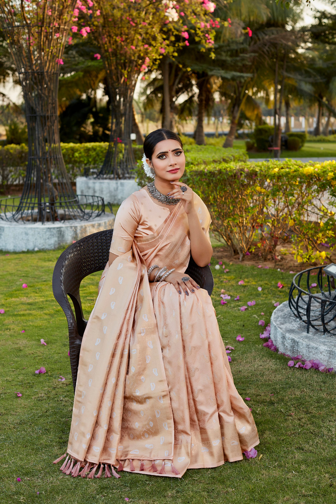 Beautiful beige satin silk saree featuring intricate butta work and a woven pallu, perfect for cultural festivities.