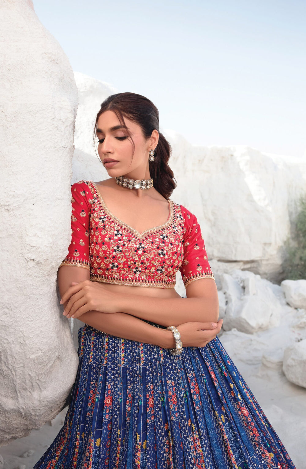 Navy blue and red designer bridal lehenga choli for women, crafted to offer elegance and style at weddings.