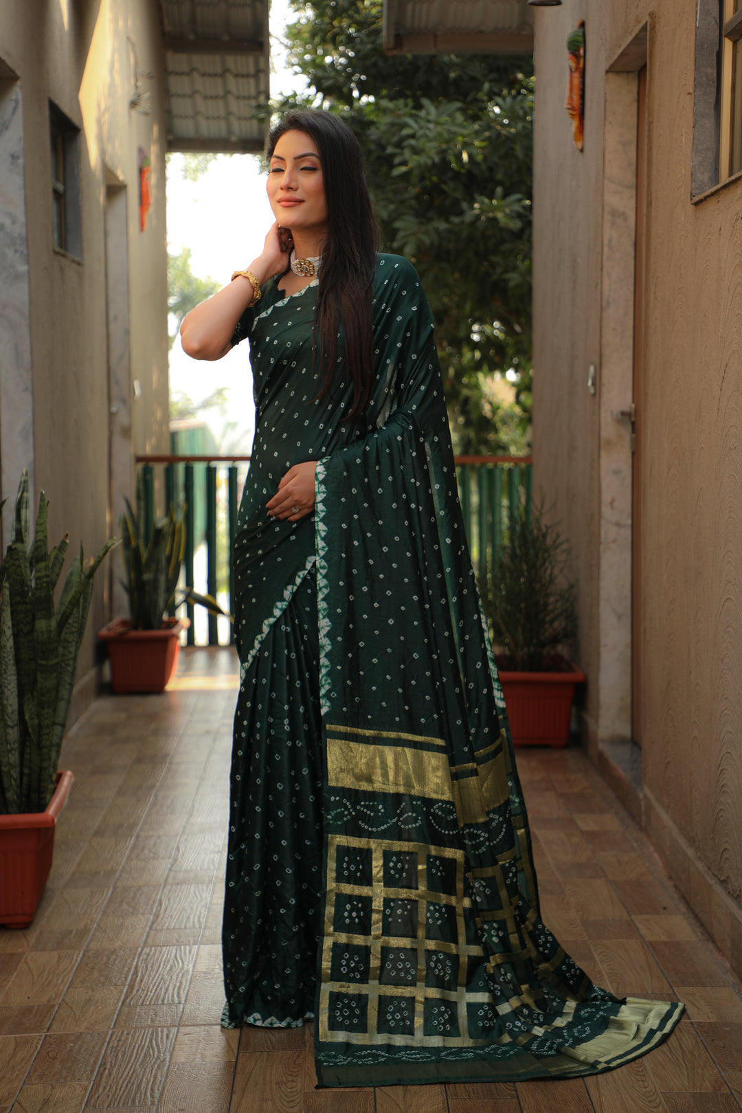 Beautiful teal-green Bandhej silk saree with original craft and checks pattern.