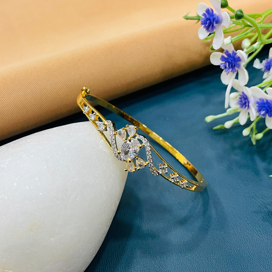 Golden bracelet with a polished bangle style, suitable for everyday elegance.