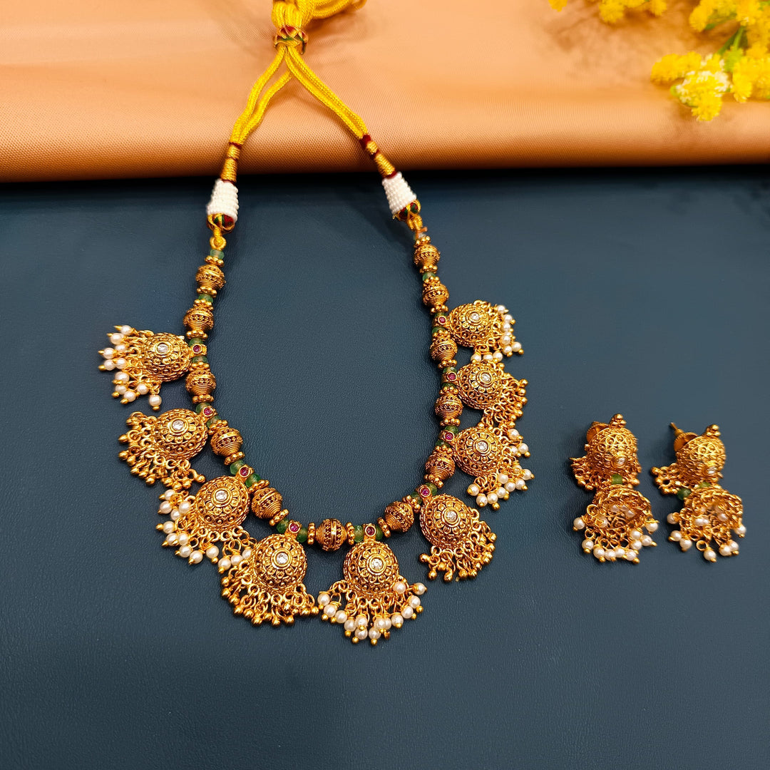 Designer Indian choker set in antique gold, a beautiful accessory for weddings and celebrations.