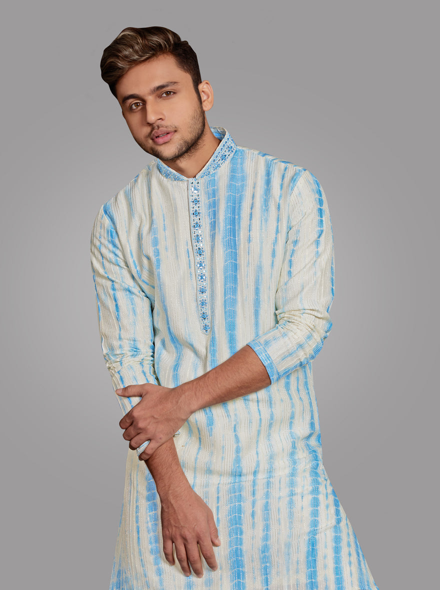 Experience luxury at your next event with this beautifully embroidered off-white kurta pajama.