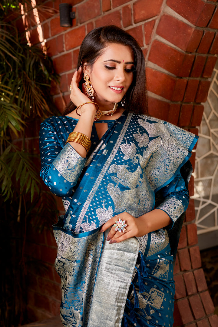 A sophisticated blue Kanjivaram soft satin silk saree with designer border and intricate weaving, perfect for weddings and celebrations.