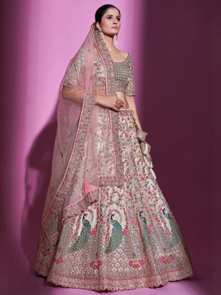 Elegant cream wedding lehenga with dori work and sequins.