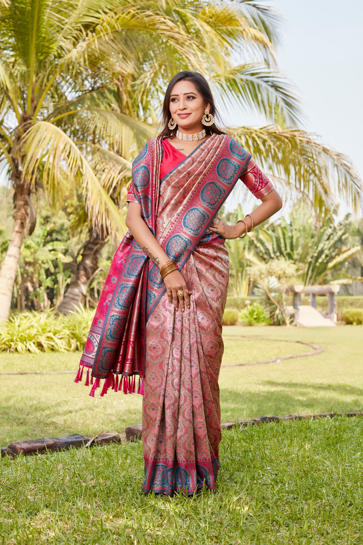 Elegant coral-pink Kanjivaram silk saree with exquisite detailing and rich pallu for festive gatherings.