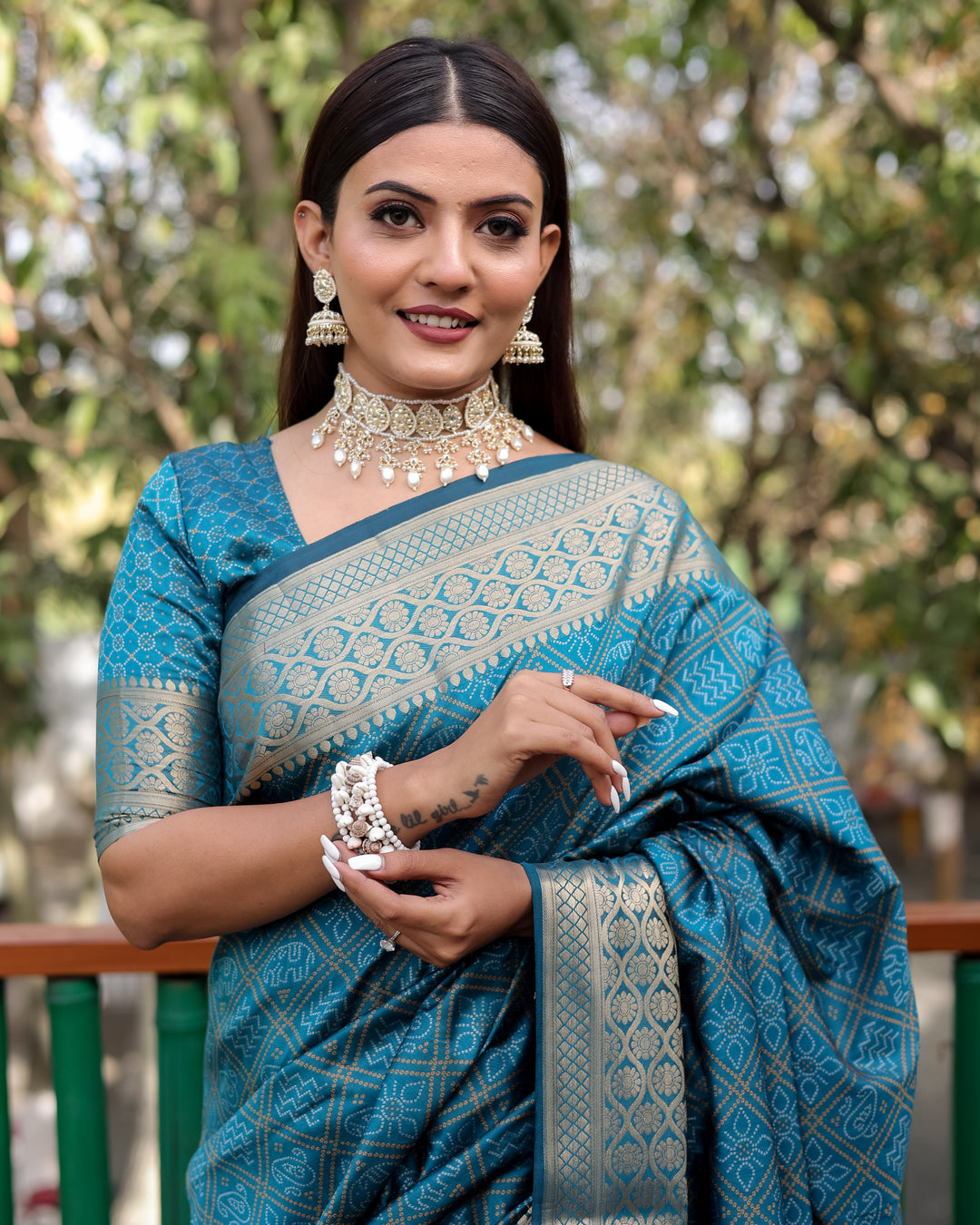 A beautiful blue Pure Handloom Bandhej Patola Silk Saree with exquisite kanchi borders, perfect for an Indian wedding.