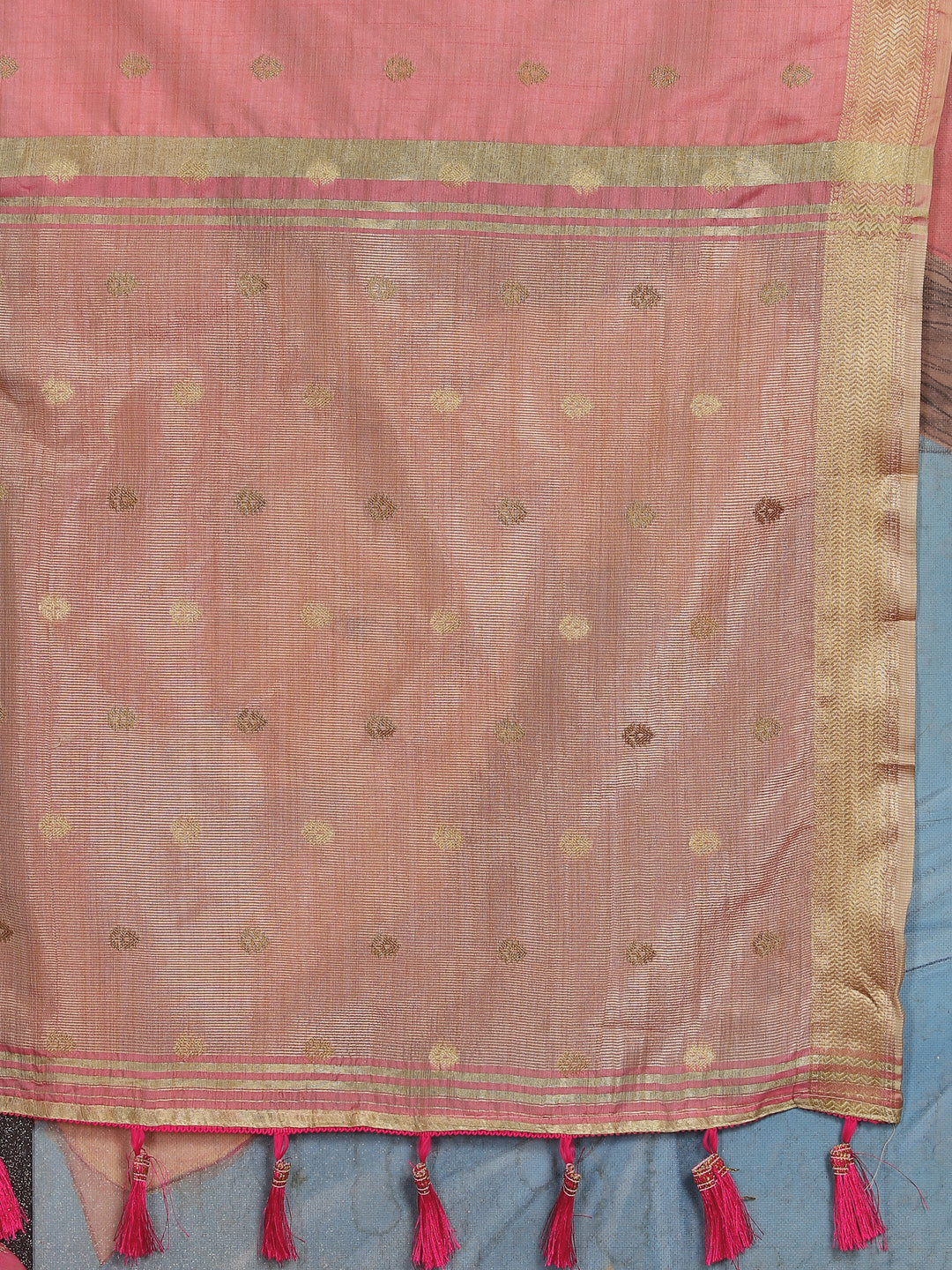 Radiant Peach Silk Saree with intricate zari patterns and designer pallu tassels for traditional events.