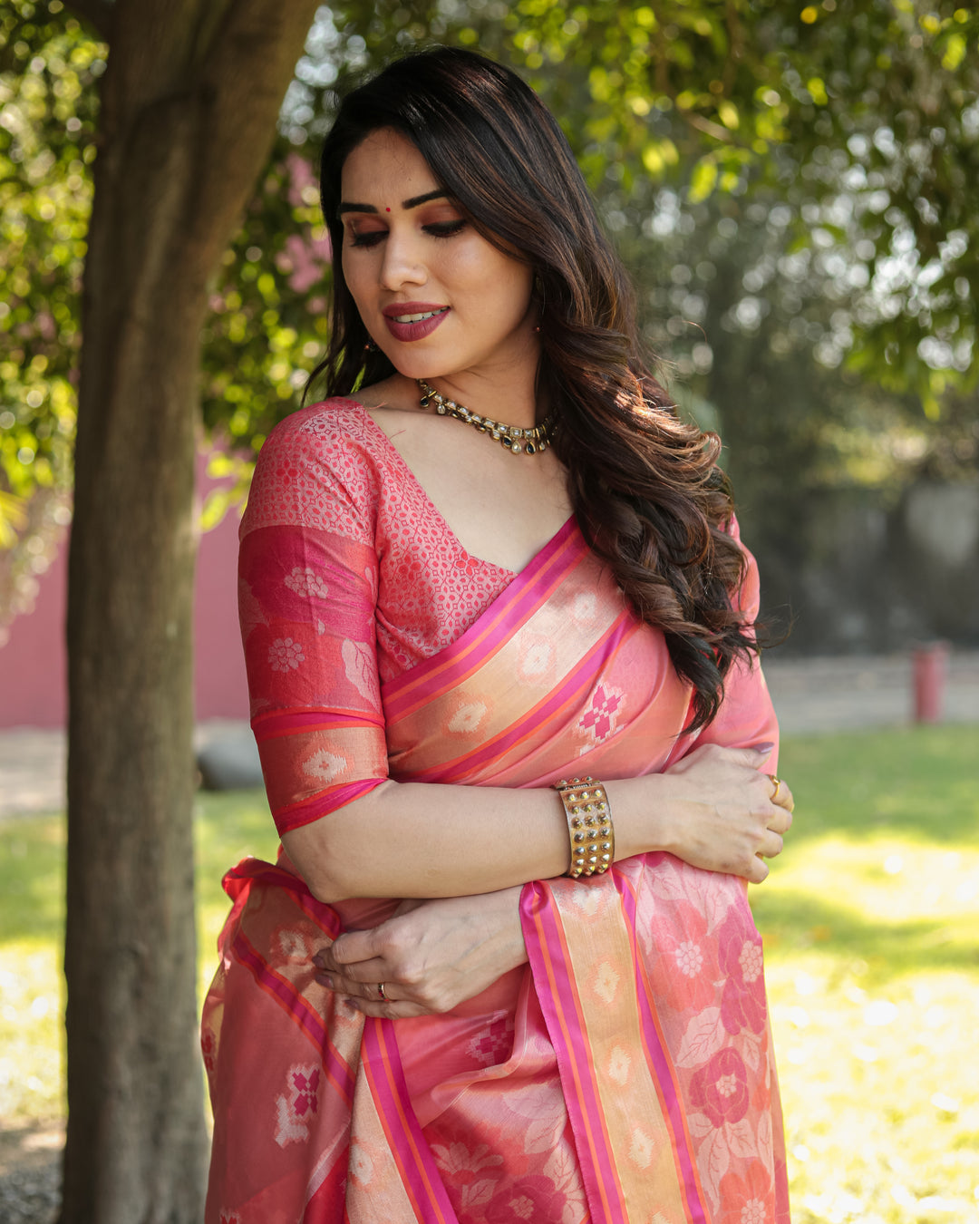 Elegant pink Ikkat weave saree with a delicate tassel-adorned pallu, ideal for any festive occasion.