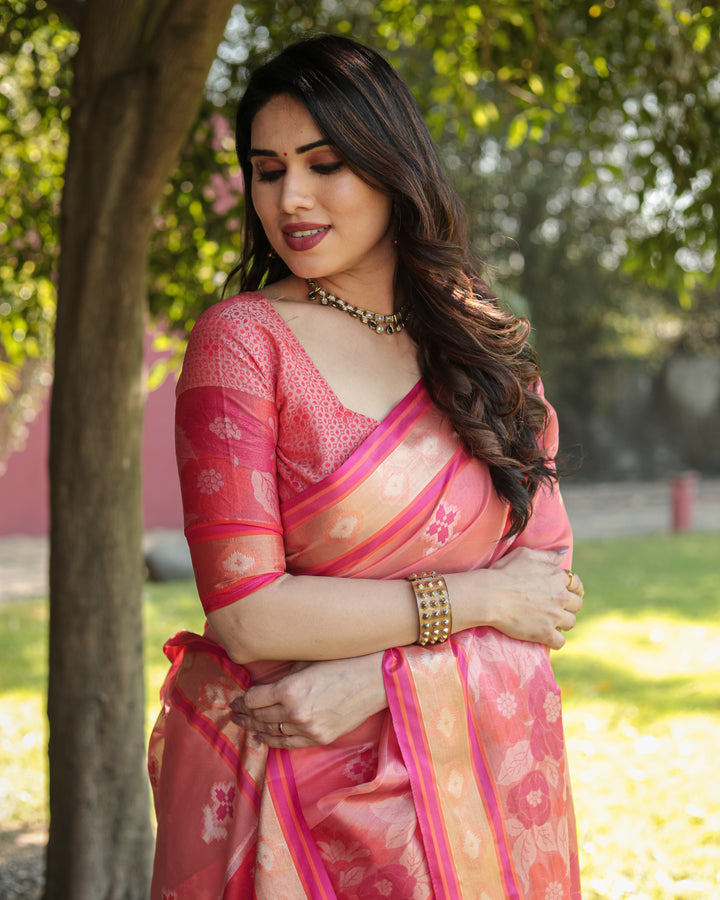 Elegant pink Ikkat weave saree with a delicate tassel-adorned pallu, ideal for any festive occasion.