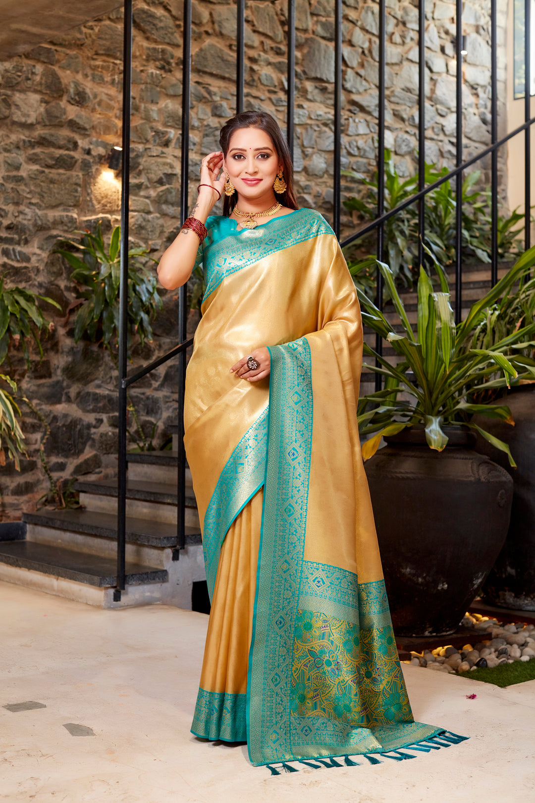 Light-peach Tissue silk saree with intricate weave and a striking contrast border design.