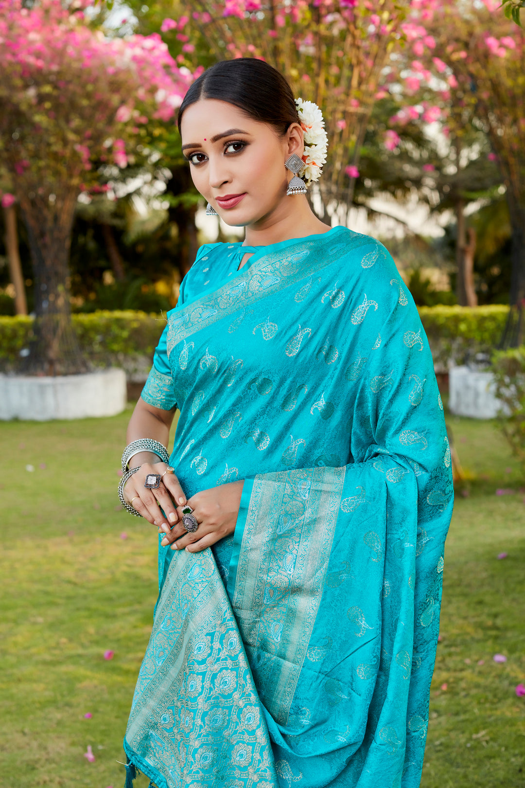 Chic sky-blue Kanjivaram satin silk saree with intricate butta designs and woven pallu, perfect for weddings.