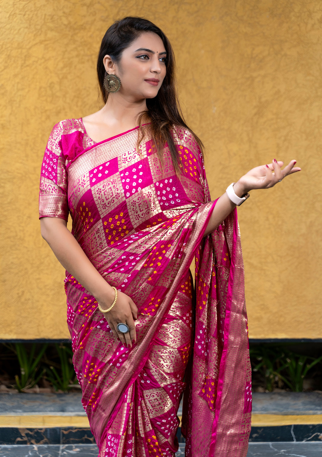 Gorgeous magenta Bandhej silk saree with a luxurious drape and zari border, perfect for bridal events.