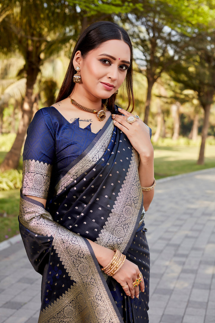 Elegant navy Satin Kanjivaram saree with intricate butta motifs and shimmering sheen.