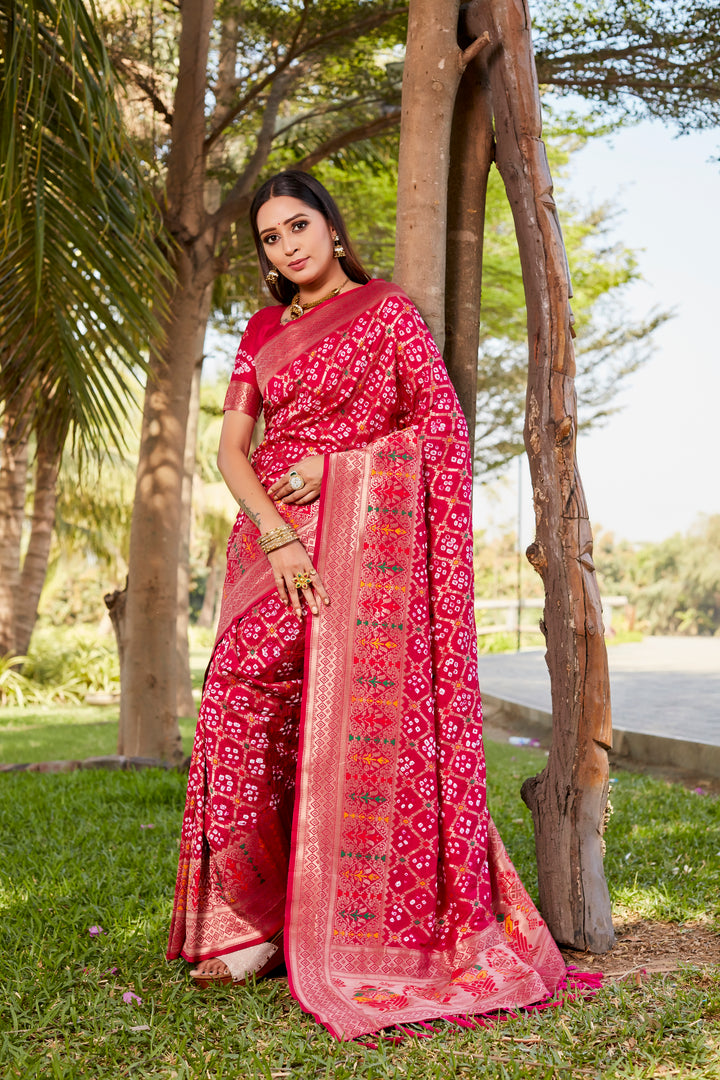 Gorgeous hot pink Gharchola Bandhej silk saree with zari weaving and meenakari borders, perfect for bridal or festive occasions.