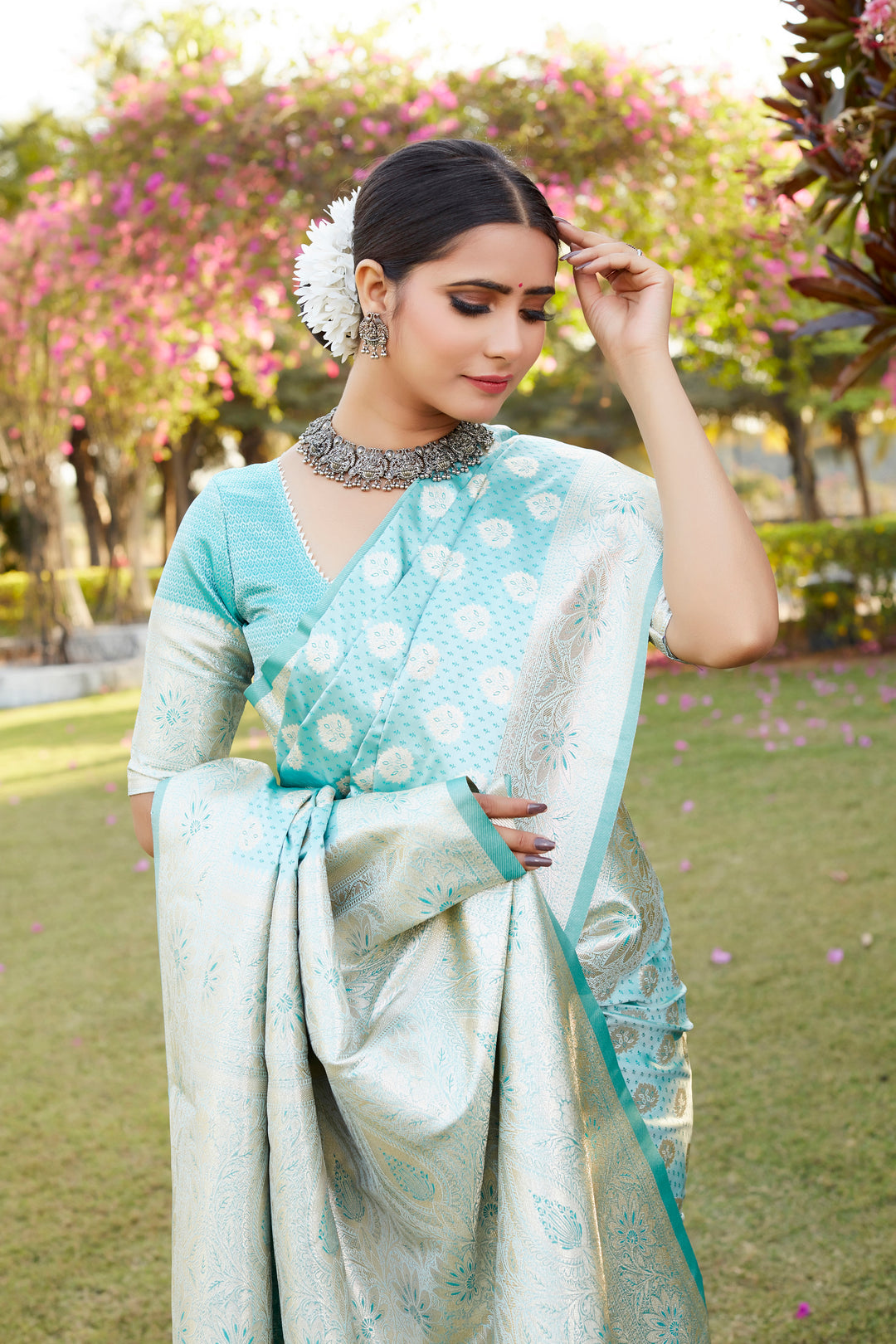 Stunning green Kanjivaram Soft Satin Silk saree with intricate butta work and a luxurious satin weaving border.