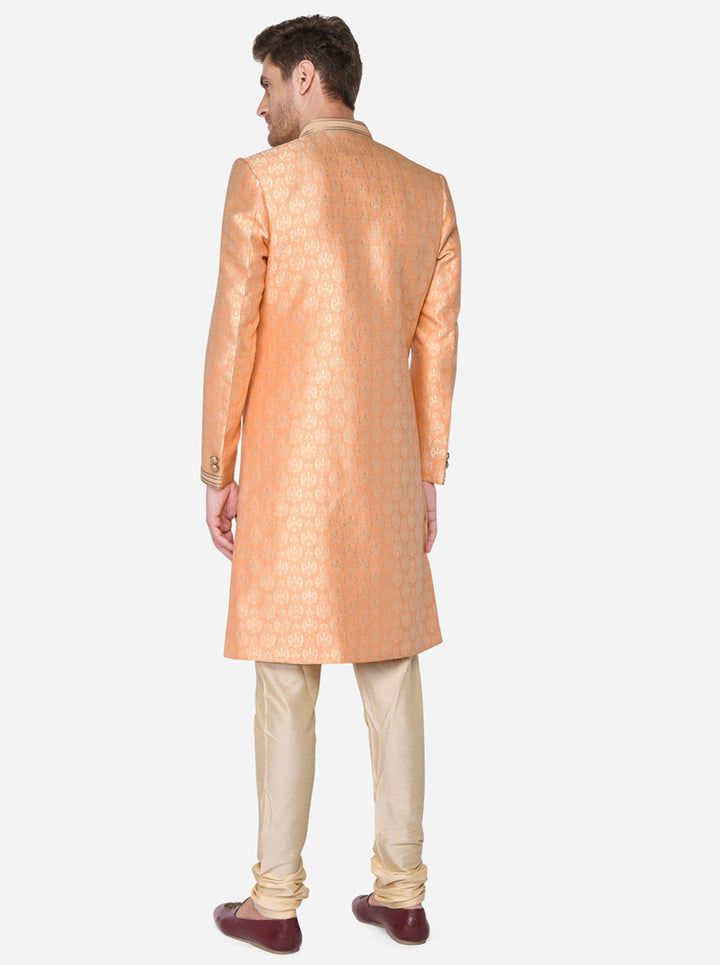 Crafted for comfort and style, this self-textured orange Sherwani is tailored for modern grooms.