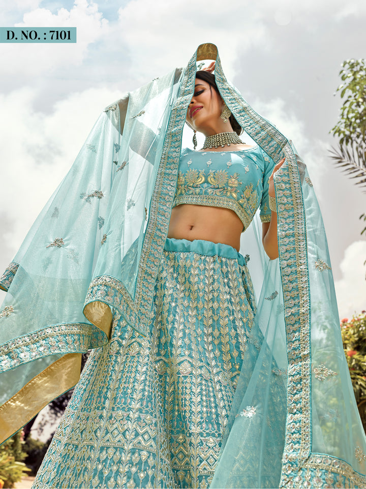 Sky blue organza lehenga choli with intricate zari, gota, resham, and sequins work, perfect for weddings and parties.