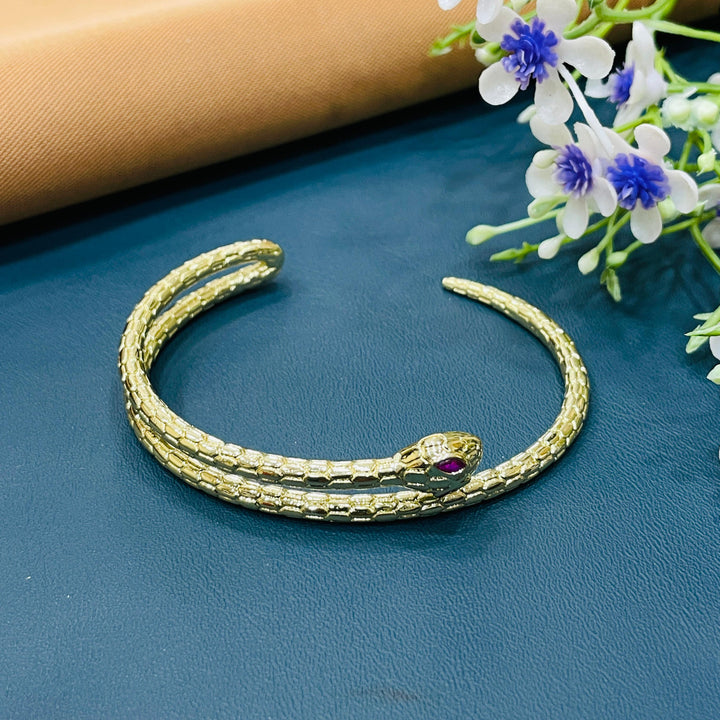 Sophisticated golden bracelet with a unique interwoven pattern, perfect for events.