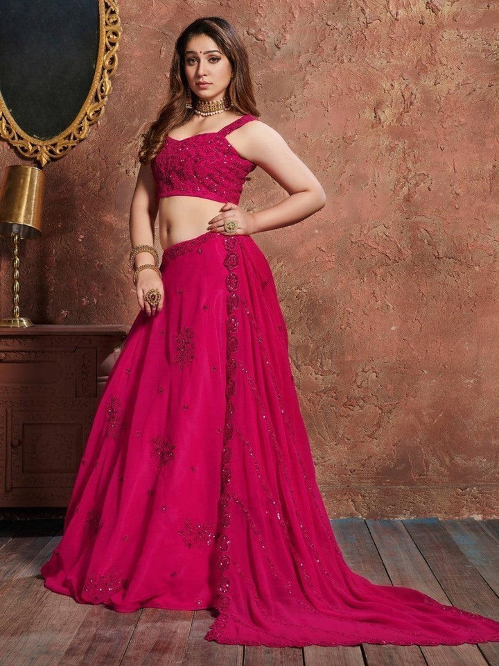 Traditional pink lehenga set with matching choli and embroidered dupatta