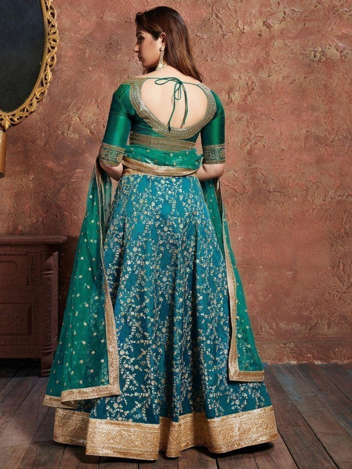 Wedding wear teal green lehenga with matching net dupatta