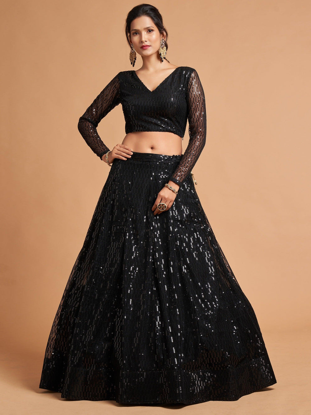 Designer black lehenga choli with can-can and intricate embroidery for a chic look.