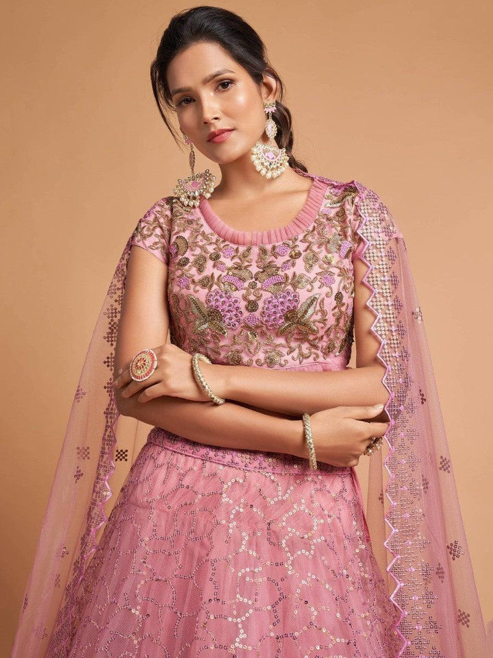 Elegant blush pink lehenga with intricate embroidery details.