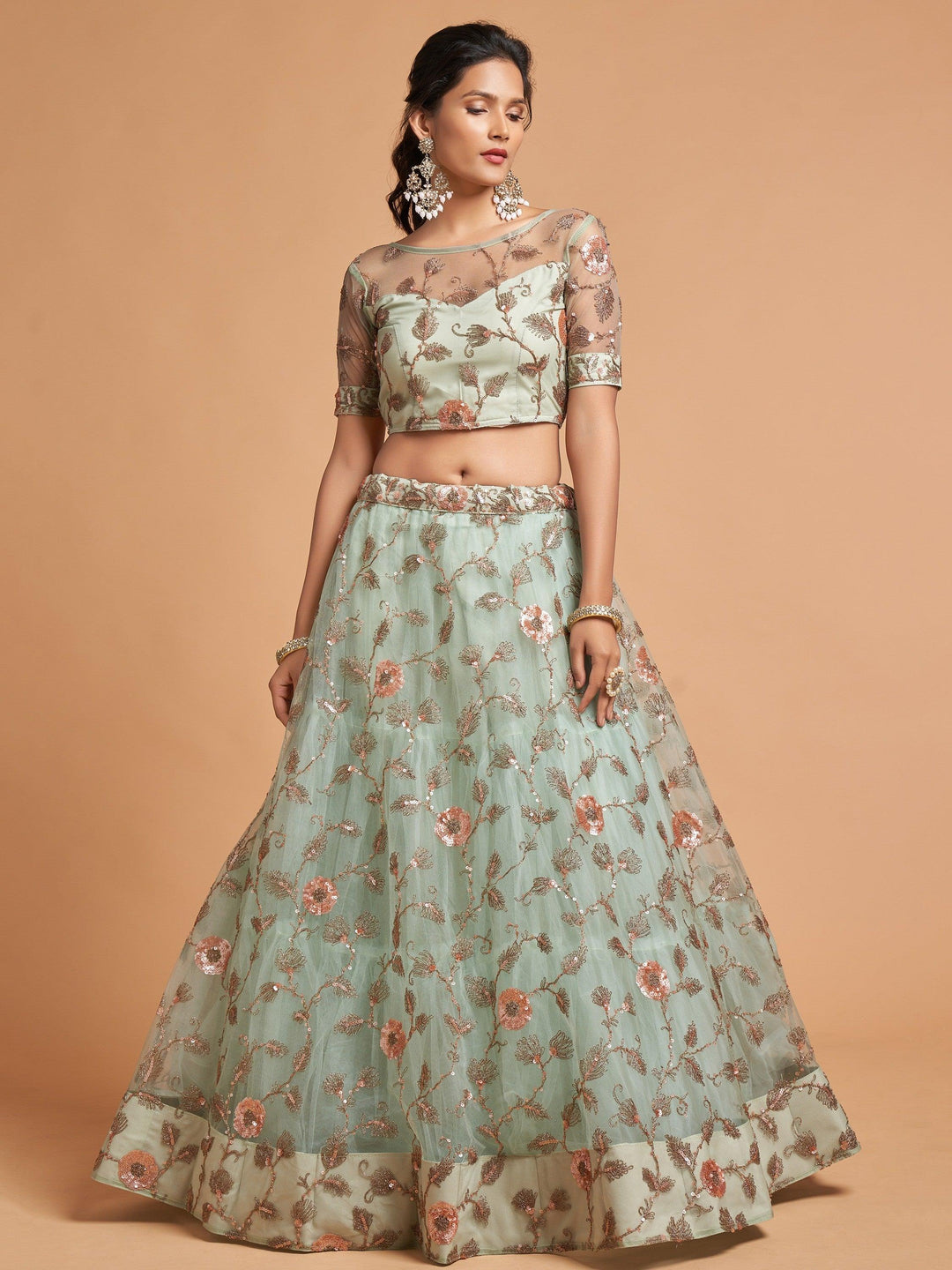 Elegant pista green engagement lehenga with intricate embroidery.